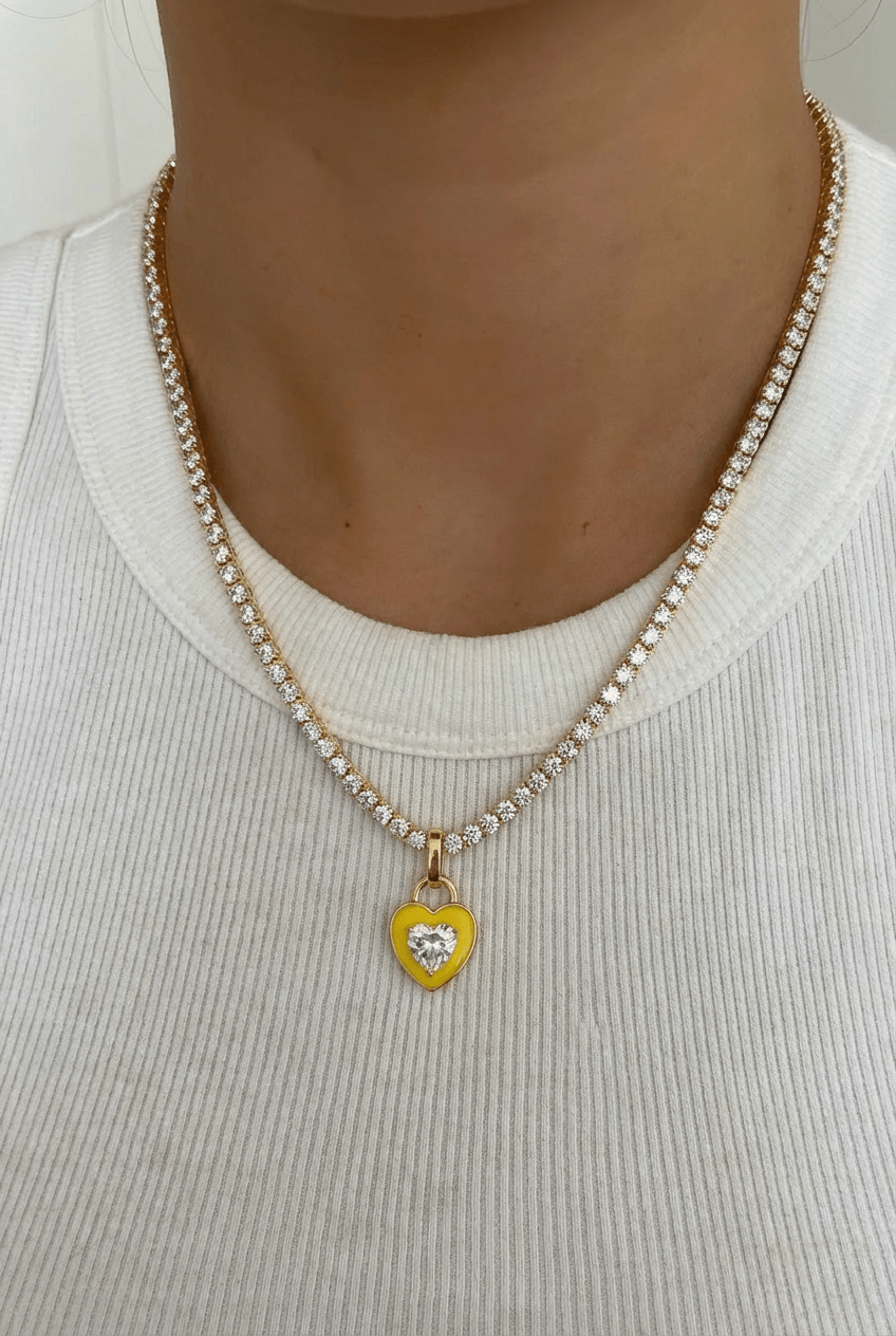 Candy Heart Necklace – Lemon Edition | Collier tennis avec pendentif cœur doré acier inoxydable zircons et email - vue en gros plan porté sur un t shirt blanc